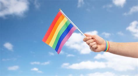 Premium Photo Hand With Gay Pride Rainbow Flag And Wristband