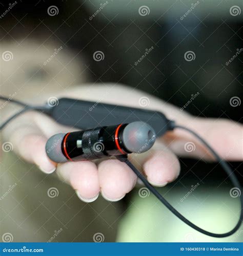 Musical Headphones In The Hand Of A Young Woman Stock Photo Image Of