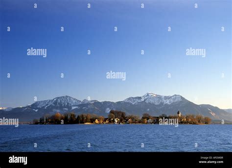 Lake Chiemsee With Island Of Frauenchiemsee And Snow Covered Hochfelln