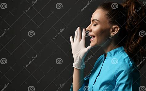 Talking Or Screaming Young Woman Doctor In Blue Medical Gown And Latex Gloves Holds Hand With