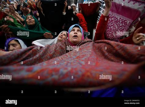 A Kashmiri Muslim Woman Raises Her Veil In Air To Pray As The Head