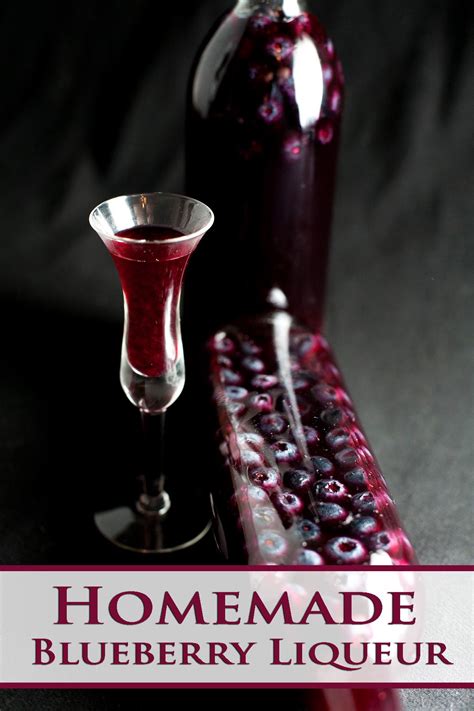 Blueberry Liqueur In A Wine Glass Next To A Bottle With The Words Homemade Blueberry Liqueur On It