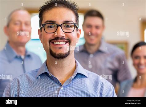 Portrait Of Smiling Businessman And Team Stock Photo Alamy