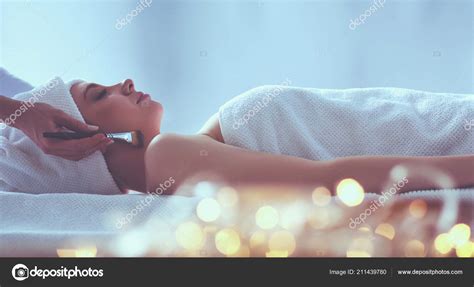 Young Woman Lying On A Massage Table Relaxing With Eyes Closed Woman