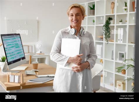 Mature Female Programmer With Laptop In Office Stock Photo Alamy