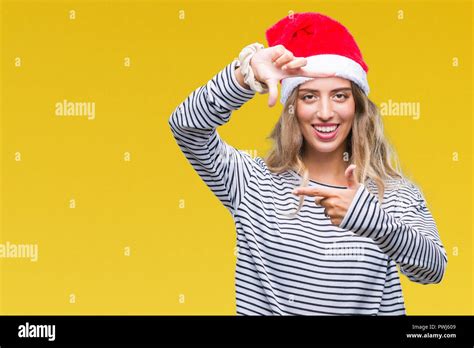 Beautiful Young Blonde Woman Wearing Christmas Hat Over Isolated