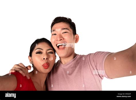 Smiling Asian Couple Taking A Selfie Isolated Over White Background