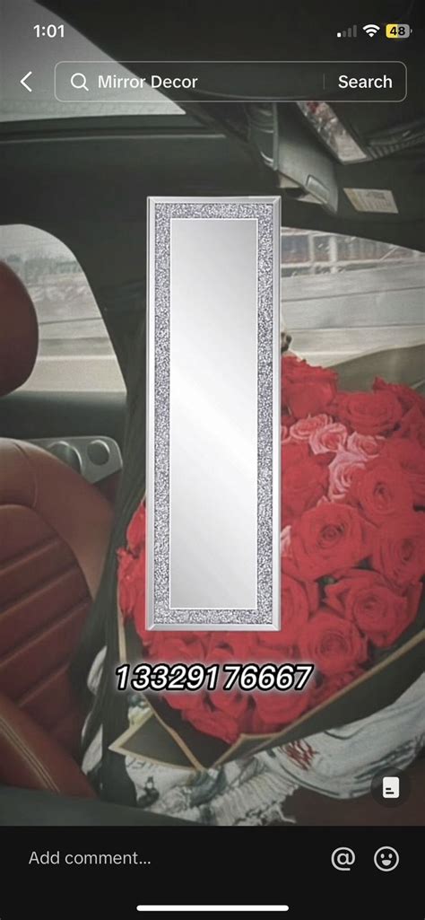 A Mirror Sitting In The Back Of A Car Filled With Red Roses