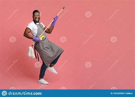 Funny African Man Using Mop Handle As Guitar Having Fun During