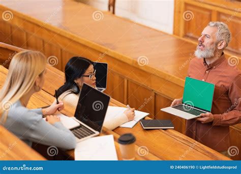 Mature Teacher Holding Laptop With Green Stock Photo Image Of Adult Asian