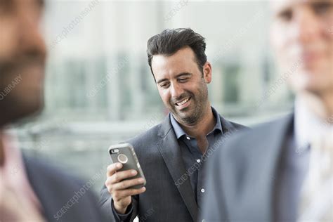 Three Men One Checking His Smart Phone Stock Image F010 7996