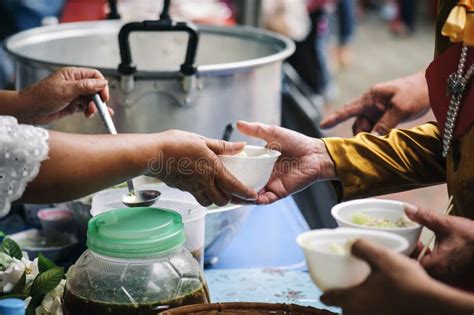 Homeless And Needy People Receive Help Receive Food From Volunteers