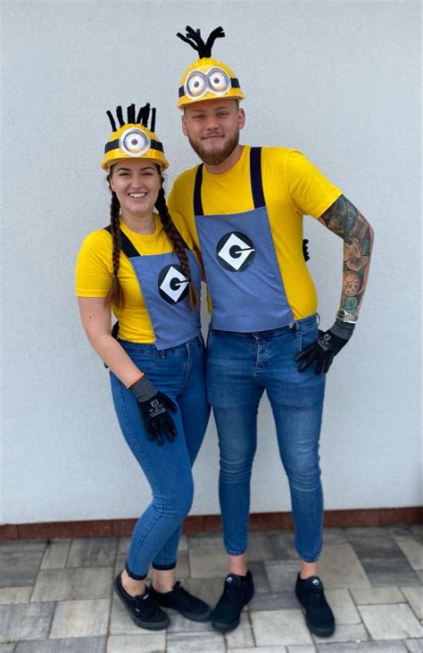 A Man And Woman Dressed Up In Minion Costumes Standing Next To Each Other