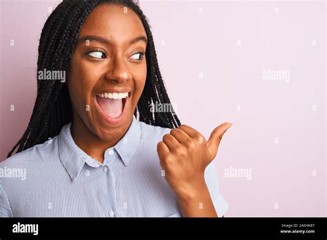 Young African American Woman Wearing Striped Shirt Standing Over