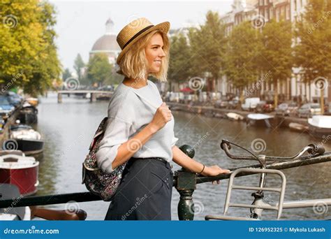 Happy Traveler Girl Enjoying Amsterdam City Smiling Woman Looking To The Side On Amsterdam