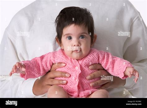 Portrait Of A Baby Girl Sitting On Mothers Lap Stock Photo Alamy