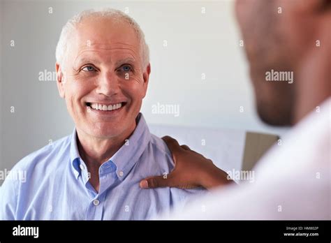 Doctor Meeting With Mature Male Patient In Exam Room Stock Photo Alamy