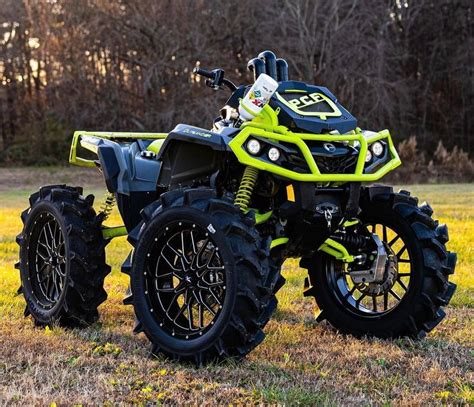 Green And Black Four Wheeler In The Grass Best Atv Quads