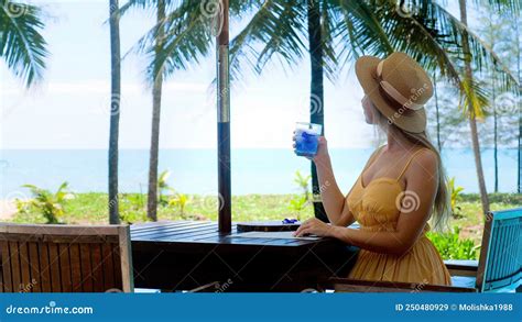 Summer Vacation In Tropical Resort Woman Sitting In Beachside Cafe And