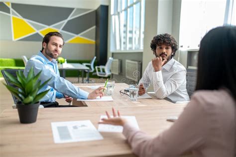 People Negotiating In The Offcie And Looking Involved Stock Image