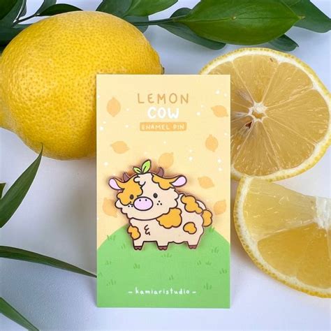 A Card With An Image Of A Cow On It Next To Lemons And Leaves