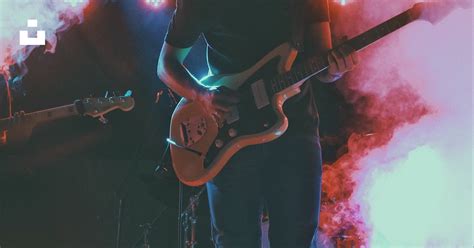 Man In Black Crew Neck T Shirt Playing Brown Electric Guitar Photo