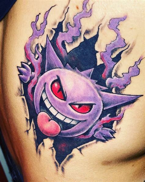 A Close Up Of A Tattoo On The Side Of A Womans Stomach With An Evil Face