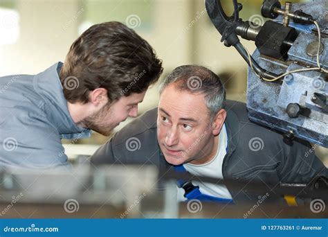 Apprentice Mechanic Working In Auto Repair Shop Stock Image Image Of