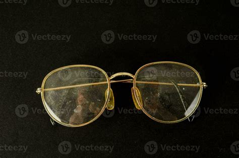 a pair of glasses with gold rims on a black background 35761653 Stock ...