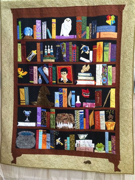 A Quilted Book Shelf Filled With Lots Of Books