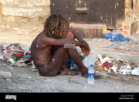 A Naked Homeless Person Sitting By The Side Of The Road In Mumbai India Stock Photo Alamy