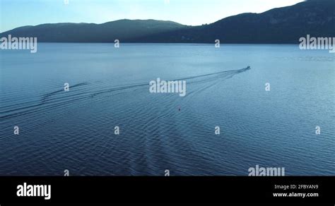 Loch Ness Wide Aerial Following Wake Behind Speed Boat And Jetski In