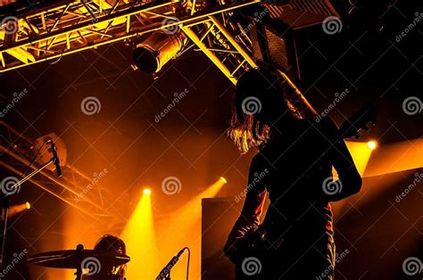 Rock Band Performs On Stage Guitarist Plays Solo Silhouette Of Guitar Player In Action On