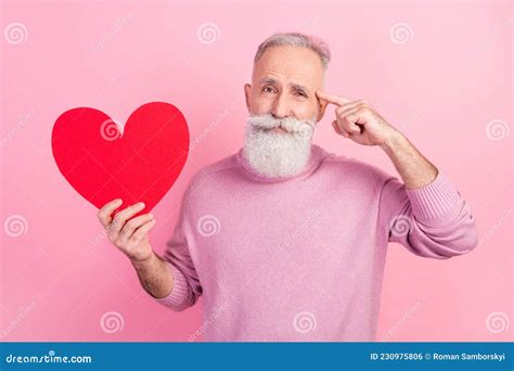 Photo Of Thoughtful Grey Hair Old Man Hold Heart Wear Pink Sweater