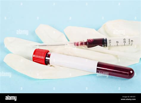 Blood sample in tube for testing with gloves and needle syringe Stock ...