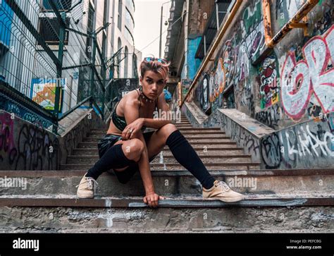 Street Punk Girl Sitting On Concrete Stairs Urban Lifestyle In City Passage Painted With