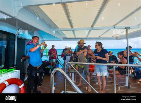 Instructor Teaching Tourists How To Use A Snorkel During A Tour To Lady