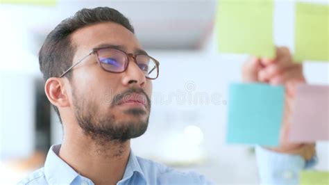 Young Happy Business Man Brainstorming And Planning A Marketing Strategy Alone In An Office At