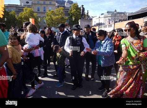 A Police Officer Dances With Members Of The Public During The Diwali On