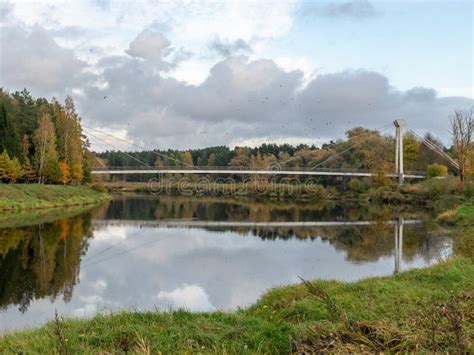 Autumn Landscape With River Bridge And Beautiful Colorful Trees River