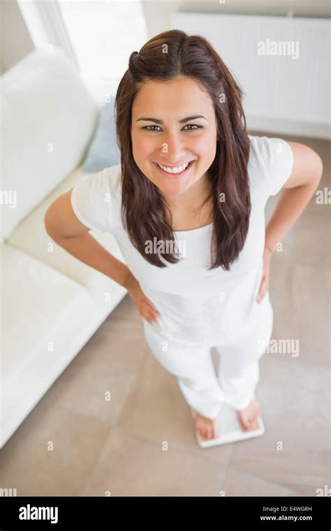 Brunette Standing On Weighing Scales Stock Photo Alamy