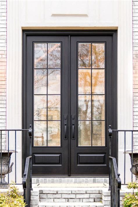 A Black Double Door With Two Sidelights And Steps Leading Up To The