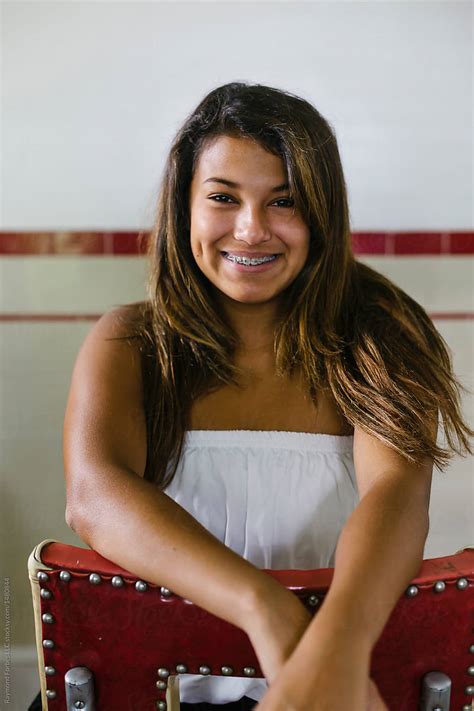 Portrait Of Hispanic Teen With Braces On Her Teeth By Stocksy Contributor Raymond Forbes Llc