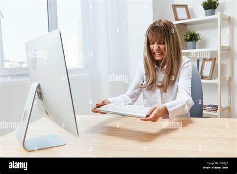 Irritated Blonde Businesswoman Screaming To Keyboard Raging After