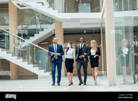 Business People Walking In The Office Corridor Stock Photo Alamy