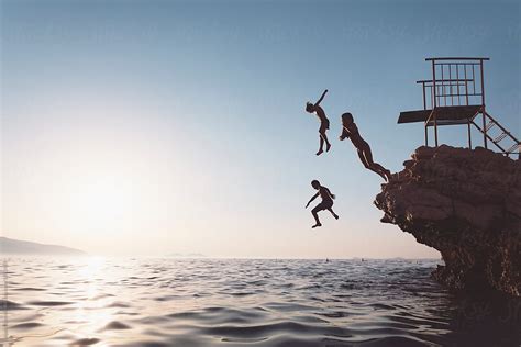 Children Enjoys Jumping From A Cliff. by Dejan Ristovski