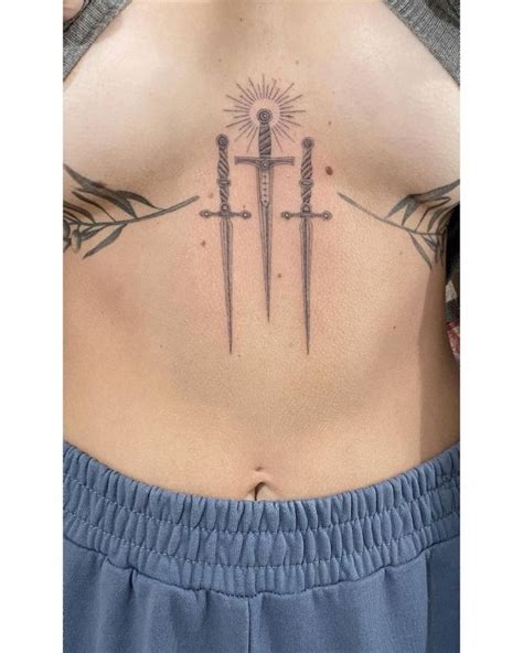 Single Needle Swords Tattoo On The Sternum