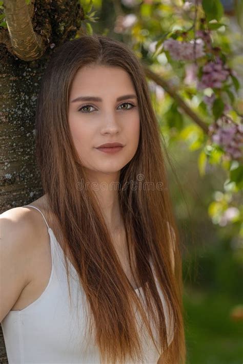 Brunette Girl Posing On Camera Outdoors Vertically Stock Photo Image