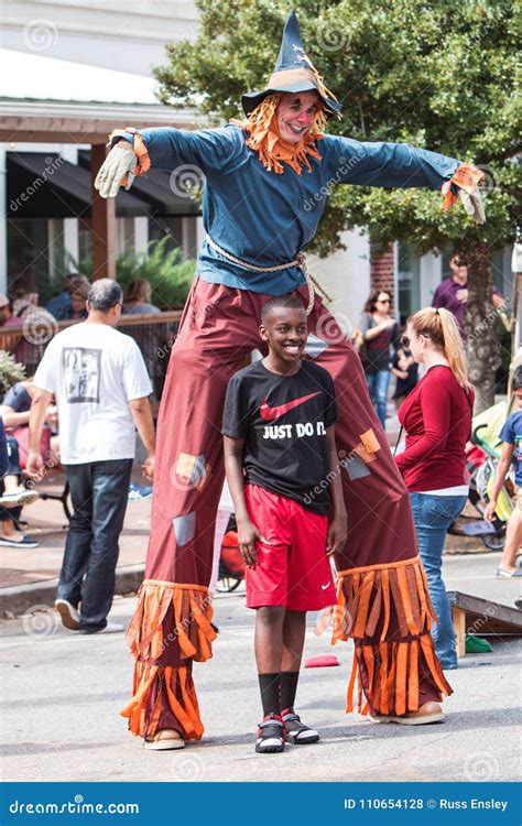 Man Wearing Scarecrow Costume On Stilts Poses For Photo Editorial Stock