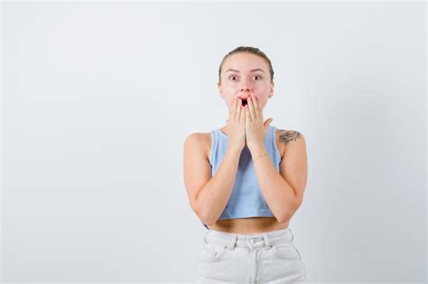 Free Photo Shocked Girl Is Closing Her Mouth With Her Hands On White